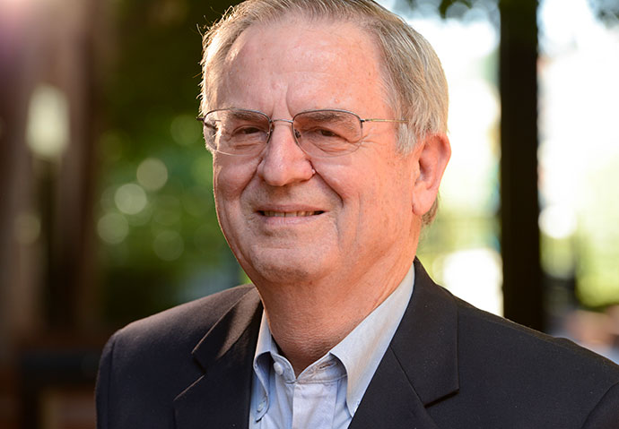 Jay Holman smiles in a portrait. 