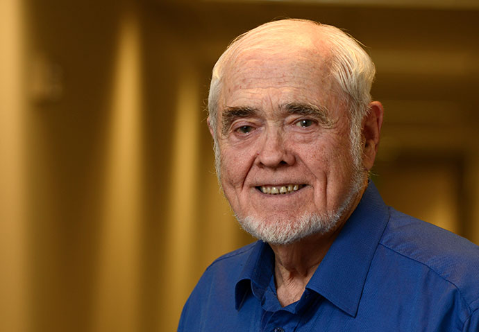 Gene Barnes smiles in a portrait.